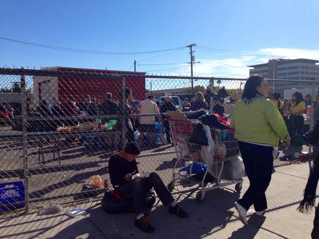 Brent Kassens dines on a Thanksgiving meal served this morning at Fremont and 6th streets in Las Vegas.