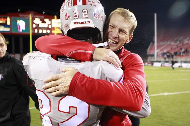 UNLV head coach Bobby Hauck hugs defensive back Mike Horsey after defeating San Diego State 45-19 in their Mountain West Conference game Saturday, Nov. 30, 2013 at Sam Boyd Stadium.