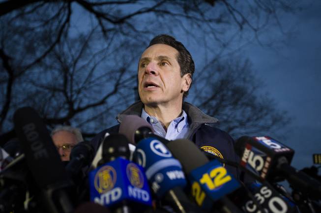 New York Governor Andrew Cuomo speaks to the media during a news conference at the scene of a Metro-North passenger train derailment in the Bronx borough of New York, Sunday, Dec. 1, 2013. The train derailed on a curved section of track in the Bronx on Sunday morning, coming to rest just inches from the water and causing multiple fatalities and dozens of injuries, authorities said. Metropolitan Transportation Authority police say the train derailed near the Spuyten Duyvil station.