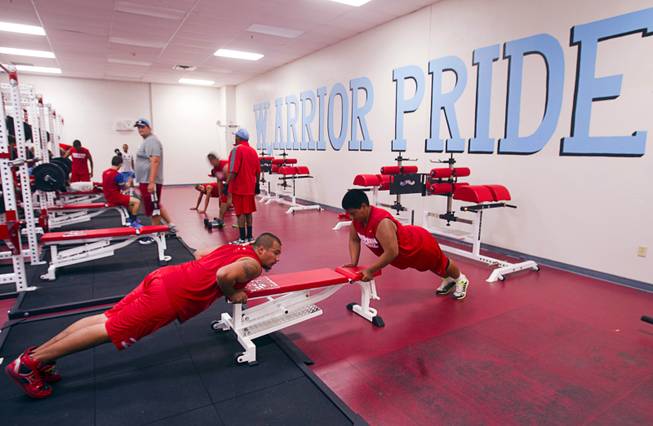 In this June 10, 2013, file photo, football players work out in an updated weight room at Western High School. Athletic facilities at Western and four other Clark County high schools were being sanitized after an outbreak of Norovirus among youth football players who used the facilities during the recent National Youth Football Championship.