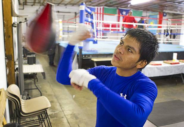 Amateur lightweight boxer Aurelio Moreno hits a speed bag during a workout at the Pochiro Boxing gym Tuesday, Dec. 3, 2013. Pochiro Boxing Promotions will hold a boxing card featuring local boxers at Sam's Town Friday.