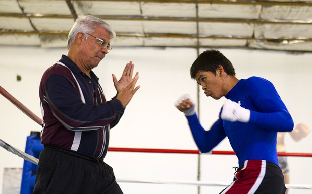 Trainer Dante Ortiz works with amateur lightweight boxer Aurelio Moreno hits a speed bag during a workout at the Pochiro Boxing gym Tuesday, Dec. 3, 2013. Pochiro Boxing Promotions will hold a boxing card featuring local boxers at Sam's Town Friday.