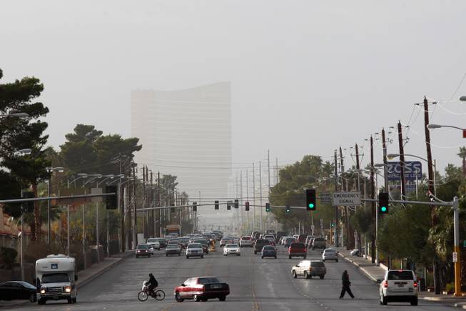 In this view looking west down Desert Inn Road, the Encore is obscured by wind-driven dust Tuesday, Dec. 3, 2013.