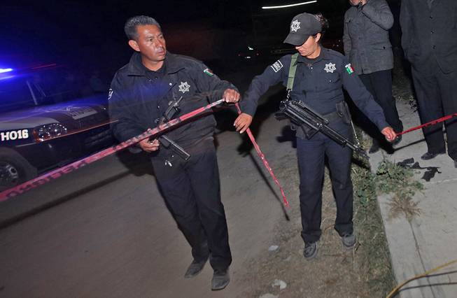 Police agents cordon off an area in the village of Hueypoxtla, Mexico, Wednesday, Dec. 4, 2013. Mexican troops and federal police kept a nighttime vigil guarding a rural field where thieves abandoned a stolen shipment of highly radioactive cobalt-60, while officials began planning the delicate task of safely recovering the dangerous material.  