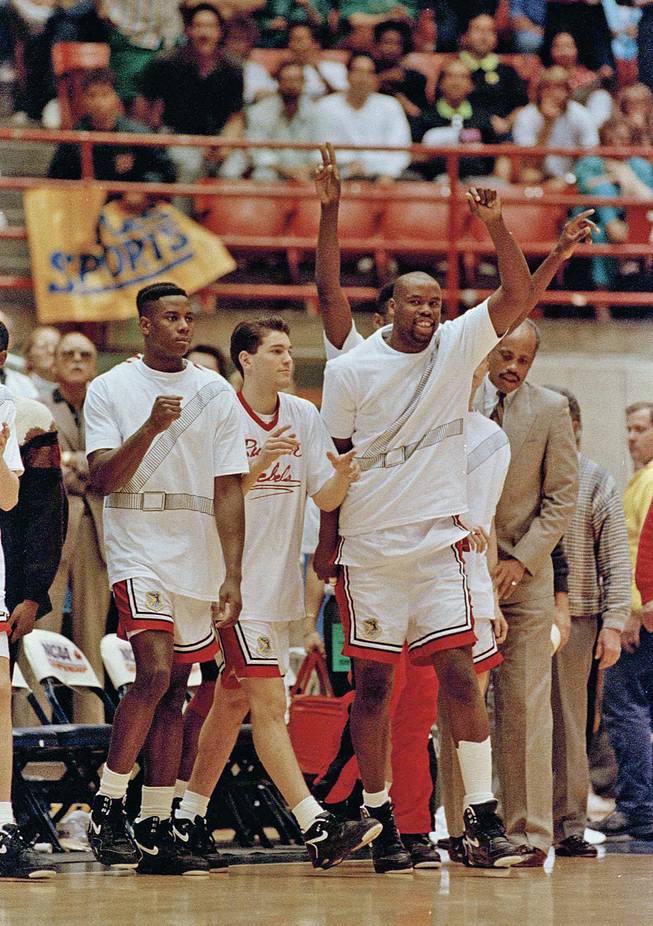 UNLV Runnin' Rebels, from left, Evric Gray, Bobby Joyce, H Waldman and Melvin Love celebrate upon winning their second-round NCAA game against Georgetown in Tucson, Ariz., March 17, 1991. 