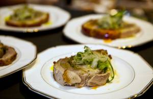 Porchetta is plated as part of the main course during La Cucina's Grand Banquet at the Venetian on Friday Dec. 6, 2013.