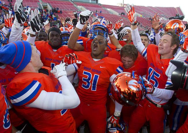 Bishop Gorman High School players celebrate after defeating Reed High School of Sparks, Nev. in the Division I state high school football championship game at Sam Boyd Stadium Saturday, Dec. 7, 2013.