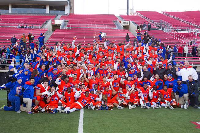 Bishop Gorman High School players and coaches pose for a team portrait after defeating Reed High School of Sparks, Nev. in the Division I state high school football championship game at Sam Boyd Stadium Saturday, Dec. 7, 2013.