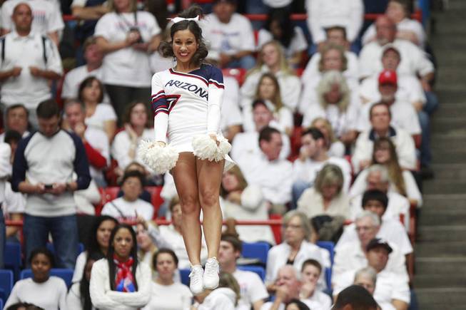An Arizona cheerleader performs during their game against UNLV at the McKale Center in Tucson Saturday, Dec. 7, 2013. Arizona won the game 63-58.