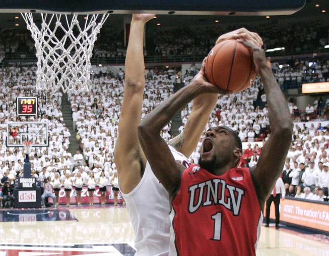 UNLV forward Roscoe Smith is fouled by Arizona while taking a shot during their game at the McKale Center in Tucson Saturday, Dec. 7, 2013. Arizona won the game 63-58.
