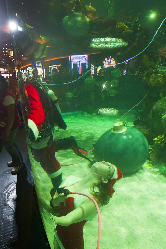 Ariana, one of Santa's helpers, makes bubble rings at the Silverton Casino Hotel in Las Vegas, Nevada December 8, 2013. The underwater Santa and his helpers greet visitors and take present requests from inside the casino's 117,000-gallon aquarium on weekends in December until Christmas.