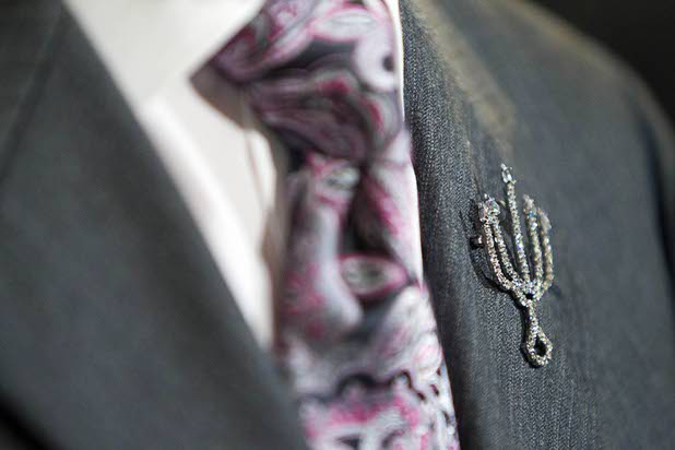 Liberace Foundation Chairman Brian "Paco" Alvarez wears a candelabra lapel pin during an open house and book launch at the Liberace house Monday, Dec. 9, 2013.  Liberace's former residence was purchased by British businessman Martyn J. Ravenhill for $500,000 in August.