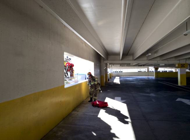 A North Las Vegas Fire Department firefighter participates in a training exercise at the Fiesta Casino parking garage Monday morning, Dec. 9, 2013.