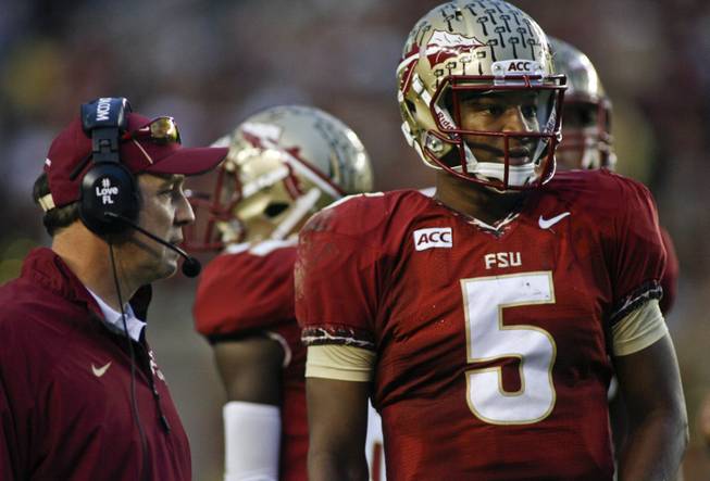 In this photo from Saturday, Nov. 23, 2013, Florida State quarterback Jameis Winston (5) looks on from the sidelines during the first half of an NCAA football game against Idaho in Tallahassee, Fla.