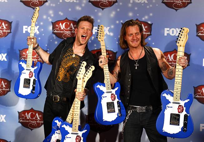 Brian Kelley and Tyler Hubbard of Florida Georgia Line stand with their awards during the 4th annual American Country Awards at Mandalay Bay Events Center on Tuesday, Dec. 9, 2013. The duo won six awards, including New Artist of the Year.