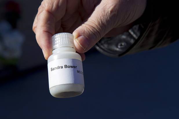 Frank Bower holds a vial containing some of his wife's ashes at Palm Boulder Highway Mortuary & Cemetery in Henderson Wednesday, Dec. 11, 2013. The vial was sent to the  Celestis who removed a portion of the ashes and sent them into space. Then they returned the remainder to Bower.