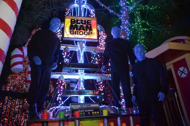Blue Man Group at their Christmas tree in the Magical Forest of Opportunity Village on Monday, Dec. 9, 2013. 