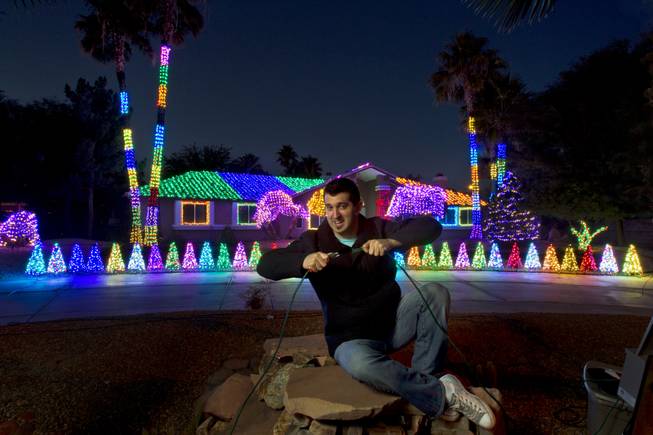 Hypnotist Marc Savard decks out his home with a light display for visitors and residents to view and admire Thursday, Dec. 12, 2013, in Las Vegas.