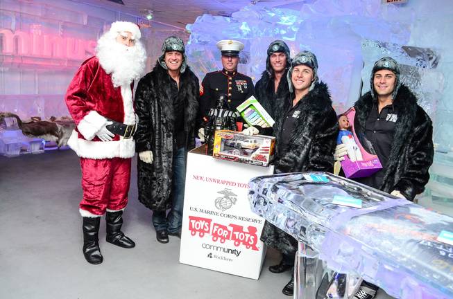 Excalibur headliners Thunder From Down Under make a Toys for Tots donation at Minus 5 Ice Bar in Mandalay Place.