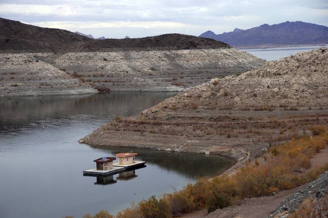 Canyon walls surrounding Lake Mead ringed with white mineral deposits where water once lapped indicate the drop in water levels Wednesday, Dec. 18, 2013, near Boulder City.