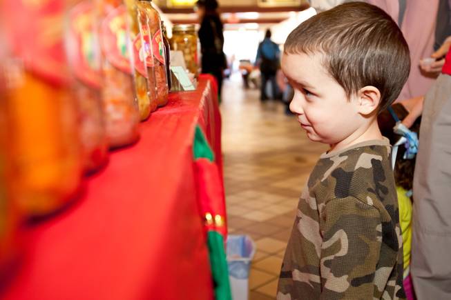 Four-year-old Nathan Meza checks out the pickled products for sale in Nick Kreway's The Pickled Pantry booth at the Downtown Farmers' Market in Las Vegas Friday, December 20, 2013.
