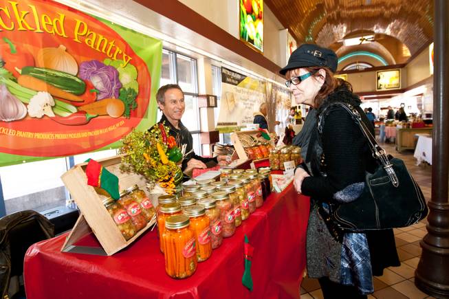 Bonnie Walker peruses the products offered for sale in Nick Kreway's The Pickled Pantry booth at the Downtown Farmers' Market in Las Vegas Friday, December 20, 2013.