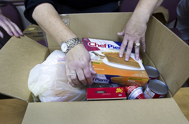 Arizona Charlie's employees pack holiday food boxes at the Boulder Highway location Monday, Dec. 23, 2013.  Casino patrons contributed loyalty card points to the Feed a Family program and bought holiday dinners for 60 families. The food baskets will be picked up by the Southern Nevada Regional Housing Authority for distribution to needy families. Each food box feeds a family of four and includes a turkey, stuffing, potatoes, gravy, vegetables, cranberry sauce, dinner rolls and pumpkin pie.