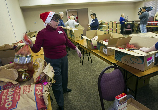 Arizona Charlie's employee Andrea Dempsey helps pack holiday food boxes at the Boulder Highway location Monday, Dec. 23, 2013. Casino patrons contributed loyalty card points to the Feed a Family program and bought holiday dinners for 60 families. The food baskets will be picked up by the Southern Nevada Regional Housing Authority for distribution to needy families.