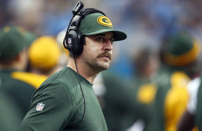In this Nov. 28, 2013, file photo, Green Bay Packers quarterback Aaron Rodgers watches from the sidelines during the fourth quarter of an NFL football game against the Detroit Lions at Ford Field in Detroit.