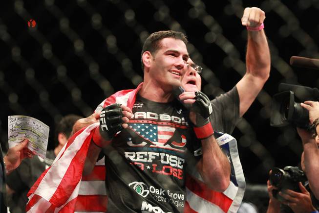 Chris Weidman wraps himself in a U.S. flag after scoring a second round TKO of Anderson Silva during their middleweight title fight at UFC 168 Saturday, Dec. 28, 2013 at the MGM Grand Garden Arena.