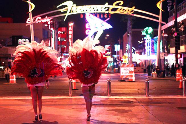Showgirl street performers are shown during New Year's Eve festivities in downtown Las Vegas Tuesday, Dec. 31, 2013. An estimated 335,000 tourists were expected to visit Las Vegas to celebrate the new year.
