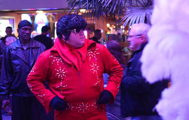 An Elvis street performer is shown during New Year's Eve festivities at the Fremont Street Experience in downtown Las Vegas Tuesday, Dec. 31, 2013. An estimated 335,000 tourists were expected to visit Las Vegas to celebrate the new year.