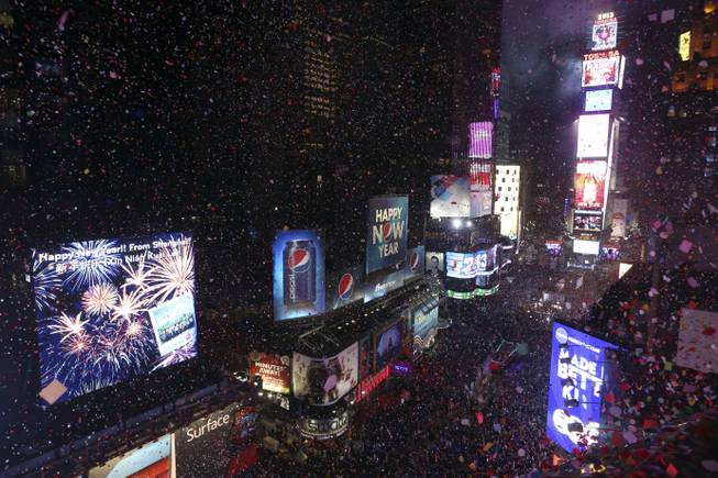 In this Jan. 1, 2013, file photo, confetti flies over New York's Times Square after the clock strikes midnight during the New Year's Eve celebration as seen from the Marriott Marquis hotel in New York. The countdown to the new year in Times Square is getting some high-profile help — U.S. Supreme Court Justice Sonia Sotomayor.