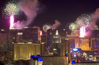 Fireworks fired from casino rooftops explode over the Las Vegas Strip just after midnight Jan. 1, 2014. An estimated 335,000 tourists were expected to visit Las Vegas for the New Year's festivities. Photo taken from the Mix nightclub at Mandalay Bay.
