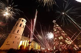 Fireworks light the sky above the Cathedral Square in Vilnius, Lithuania shortly after midnight during the New Year's Eve celebrations, Wednesday, Jan. 1, 2014. Thousands of people celebrated the beginning of the New Year 2014  in the Lithuanian capital.