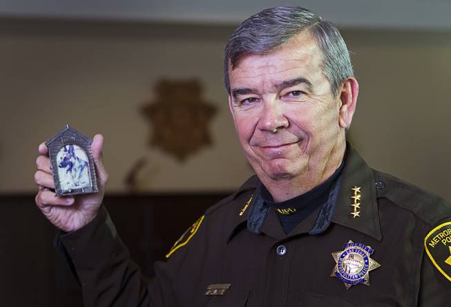 Sheriff Doug Gillespie poses with a photo of Danko, his former police dog, during an interview in Metro Police Headquarters Thursday, Jan. 2, 2014.  Gillespie was a K-9 officer from 1990 to 1993 and adopted  Danko after the dog retired. Danko passed away in 1997.