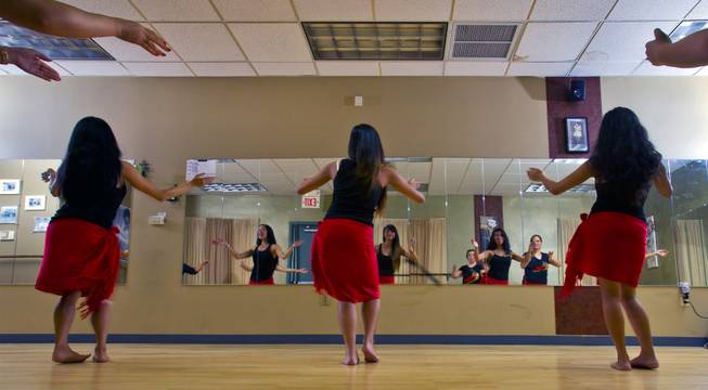 A hula workout class at the Self Quest Institute Dance Studio is reflected in the mirror on Friday, Jan. 3, 2014.