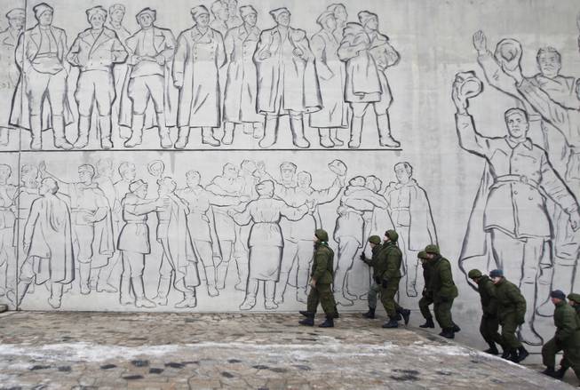 Russian soldiers patrol the Battle of Stalingrad memorial in Volgograd, Russia, Tuesday, Dec. 31, 2013. Russian authorities ordered police to beef up security at train stations and other facilities across the country after a suicide bomber killed 14 people on a bus Monday in the southern city of Volgograd. It was the second deadly attack in two days on the city that lies just 400 miles (650 kilometers) from the site of the 2014 Winter Olympics.