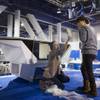 Ly Nguyen of Vietnam cleans a glass desktop at the Tosy Robotics Joint Stock Company booth during set up for the 2014 Consumer Electronics Show (CES) at the Las Vegas Convention Center Saturday, Jan. 4, 2014.