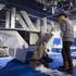 Ly Nguyen of Vietnam cleans a glass desktop at the Tosy Robotics Joint Stock Company booth during set up for the 2014 Consumer Electronics Show (CES) at the Las Vegas Convention Center Saturday, Jan. 4, 2014.