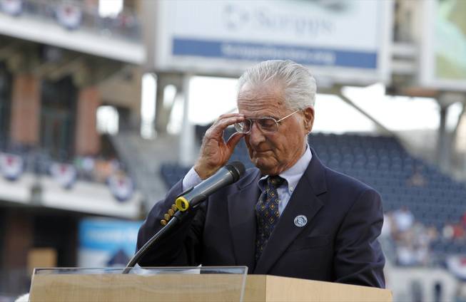 San Diego Padres radio announcer Jerry Coleman holds back tears during a ceremony honoring his 70 years in baseball, 40 of them with the Padres, and to honor for his service in the Marine Corps, before the game between the Padres and the Colorado Rockies in San Diego on Saturday, Sept. 15, 2012.