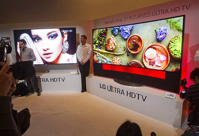 Journalists get an early look at a curved OLED Ultra HD television by LG Electronics during the 2014 International Consumer Electronics Show (CES) in Las Vegas, Monday Jan. 6, 2014.