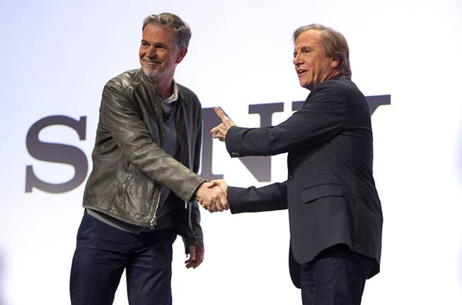Netflix CEO Reed Hastings (L) shakes hands with Mike Fasulo, president and COO of Sony Electronics Inc., during a Sony news conference at the International Consumer Electronics Show (CES), in Las Vegas, Monday Jan. 6, 2014. Hastings talked with Fasulo about streaming 4K content.