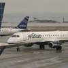 A JetBlue airplane taxis to park at a gate at Logan Airport, Monday, Jan. 6, 2014, in Boston. JetBlue announced today it would offer a new nonstop route later this year from Las Vegas McCarran International Airport to Fort Lauderdale-Hollywood, Fla., International Airport.