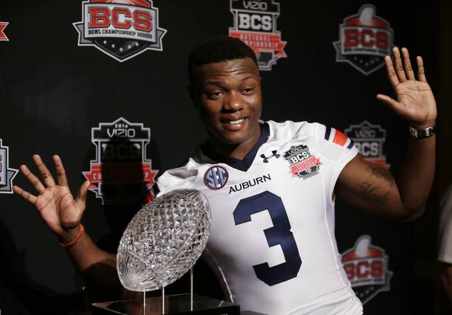 Auburn's Dominic Walker poses with The Coaches' Trophy during media day for the NCAA BCS National Championship college football game Saturday, Jan. 4, 2014, in Newport Beach, Calif. Florida State plays Auburn on Monday, Jan. 6, 2014.