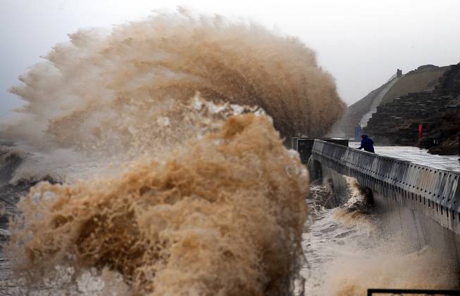 Waves crash onto the promenade between Fleetwood and Blackpool, as high tides and huge waves hit the North West England, Monday Jan. 6, 2014. 