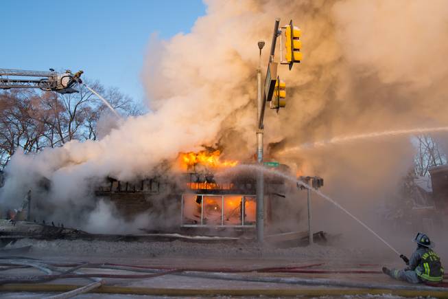 Ann Arbor firefighters battle a fire at Happy's Pizza in Ann Arbor, Mich., on Tuesday, Jan. 7, 2014.   Firefighters worked for several hours in temperatures that dipped to 15 degrees below zero to extinguish a blaze at the pizza shop. No injuries were reported following the fire.