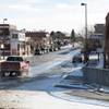In this Jan. 2, 2014, photo, a pickup truck sporting Wyoming-themed mud flaps and a brush guard in front drives down Main Street in Lusk, Wyo. Electric cars are all but unheard of around here, but last month Tesla installed four of its Supercharger units in the courtyard of the Covered Wagon Motel in Lusk. 