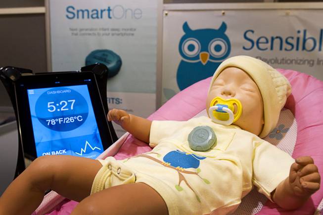 A SmartOne infant sleep monitor is shown on a doll at the Sensible Baby booth during the 2014 International Consumer Electronics Show (CES) in Las Vegas, Jan. 8, 2014. The wearable device, fits into a chest pocket, and sends information and active alerts on temperature, baby orientation and breathing to a parent's mobile device. The device will retail for $149.00 and be available online in the second quarter of 2014.