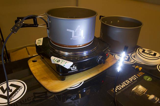A PowerPot X uses thermoelectric technology to generate power for an LED light during the 2014 International Consumer Electronics Show (CES) in Las Vegas, Jan. 8, 2014. The pot which can charge two mobile devices at once through a USB port will retail for about $255.00 and is expected in stores in May 2014. The device is designed for outdoor enthusiasts.